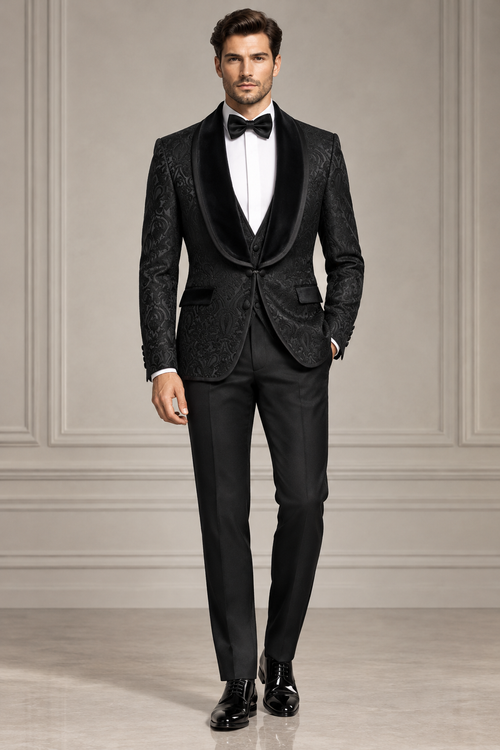 Front view of a model wearing a black patterned tuxedo with shawl lapels, white shirt and black bow tie.
