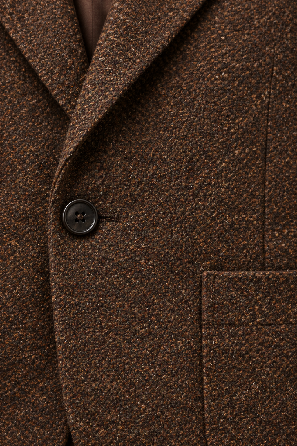 Brown Tweed Blazer Jacket fabric detail beside a dark button and patch pocket edge.