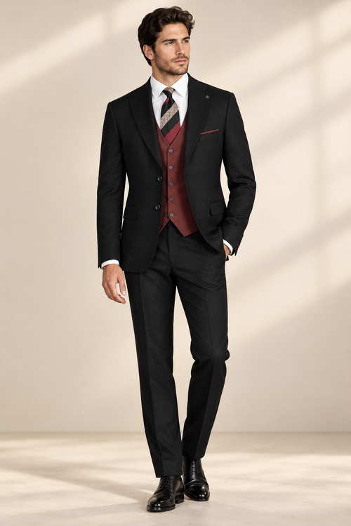 Model wearing a black three-piece suit with a burgundy vest, white shirt, striped tie and black shoes.