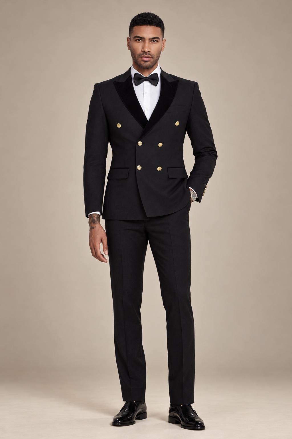 Front view of a model wearing a black double-breasted tuxedo with peak lapels and six gold buttons.